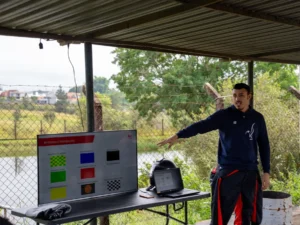 Instrutor apresenta as bandeiras de sinalização do automobilismo durante briefing antes de atividade em pista.
